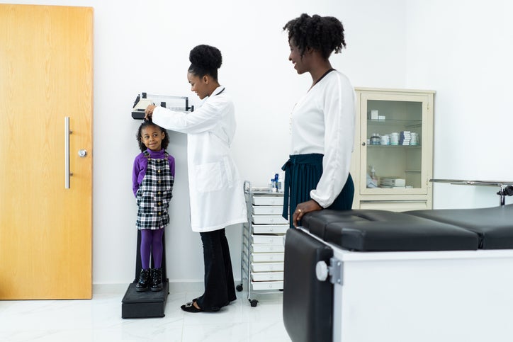 child being checked by doctor