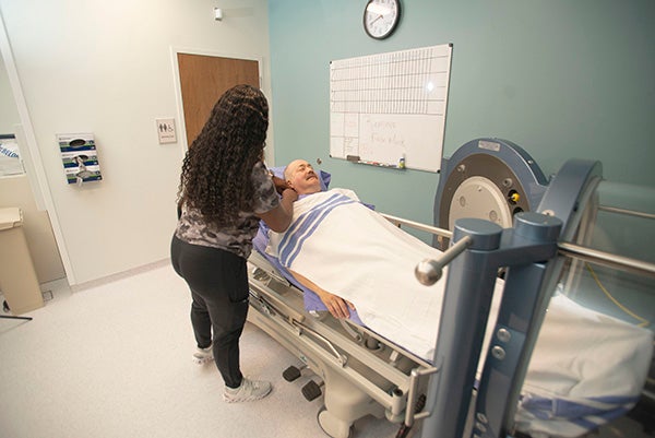 Patient being prepped by provider to go into hyperbaric chamber