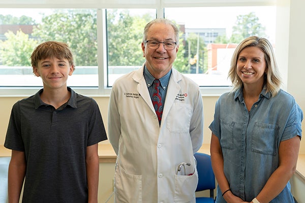 cannon smiling with surgeon and mom