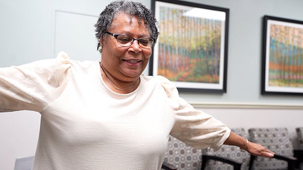 Pauline waving arms in rehab