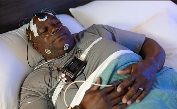 man sleeping with probes with sleep apnea