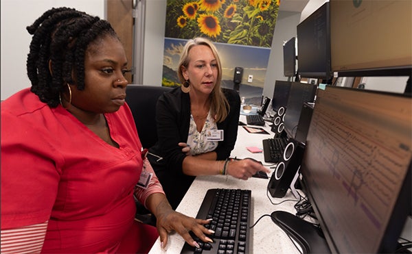 Technicians monitoring a man with sleep apnea