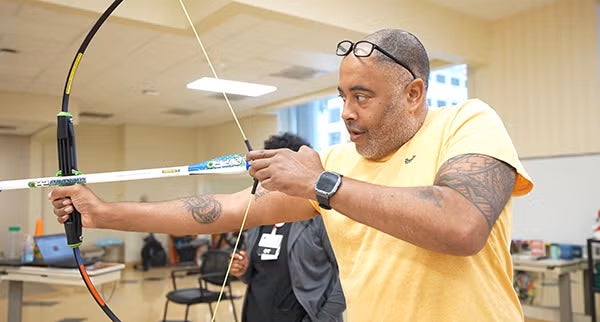 JT with bow and arrow