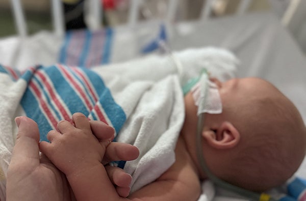 side view of baby in hospital on oxygen