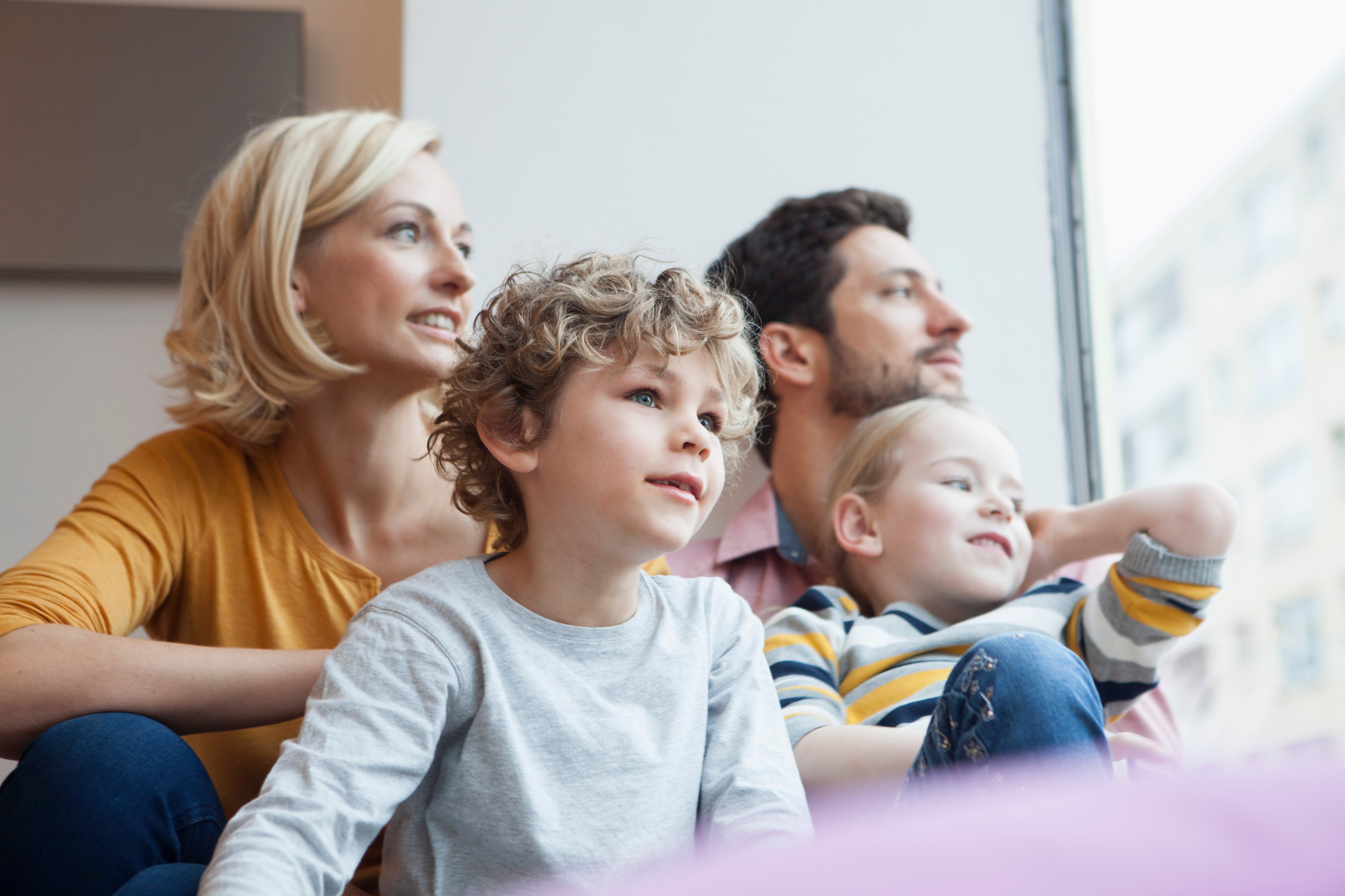 family on couch looking out the window